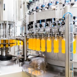 Water bottling line for processing and bottling orange carbonated juice into bottles.
